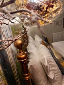 a bedroom with a bed with a chandelier above it at Hambrook Guest Suites and Private ESPA Spa in Canterbury