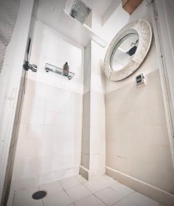 a bathroom with a mirror and a shower at Jet's Gay Youth Hostel in Puerto Vallarta