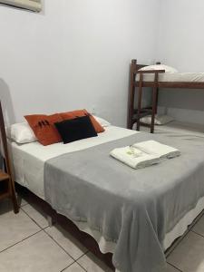 a bed with two towels on it in a room at Pousada São Jorge in Bonito
