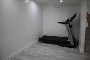 a room with a treadmill next to a wall at 5 bedroom house to share with your family and friends in Provo