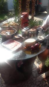 a table filled with food on top of it at Cantinho da Gigi in Peruíbe