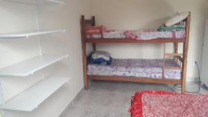 a room with two bunk beds in a room at Cantinho da Gigi in Peruíbe