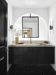 a bathroom with a sink and a mirror at Television Host and Designer Bobby Berk Invites You To His Desert Oasis in Palm Desert