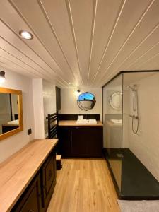 La salle de bains est pourvue d'une douche en verre et d'un lavabo. dans l'établissement Bel appartement familial et cosy, à Saint-Gervais-les-Bains