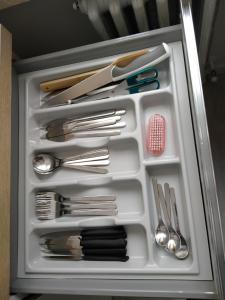 a drawer full of utensils in a refrigerator at Monolocale a 150m da impianto di risalita Spinale CIPAT O22247-AT-O11471 in Madonna di Campiglio