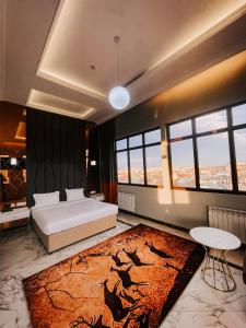 a bedroom with a bed and a rug at Hotel Resident Bishkek, Отель Резидент Бишкек 2021Opening in Bishkek