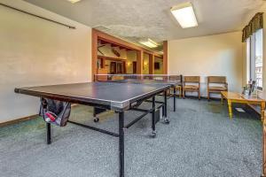 a ping pong table in a room with chairs at Timberbrook B210 in Brian Head