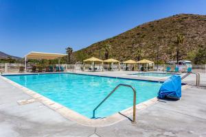 a swimming pool with a mountain in the background at Pio Pico Camping Resort One-Bedroom Cabin 14 in Jamul +7 photos
