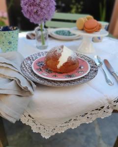 a table with a plate with a pastry on it at Ti vengo a cercare Bed & Breakfast in Castellaro
