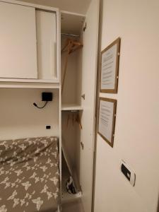 a walk in closet with a cabinet and a shelf at Monolocale a 150m da impianto di risalita Spinale CIPAT O22247-AT-O11471 in Madonna di Campiglio