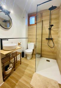 a bathroom with a toilet and a glass shower at Hostel Plaza Mayor Corredera in Córdoba