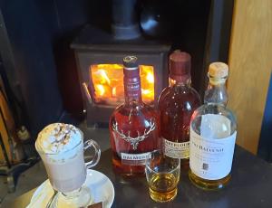 a table with two bottles of wine and two glasses at Victoria Hotel in Portknockie