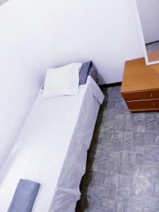 a bed sitting in a room with a table at Barcelona Centric in Barcelona