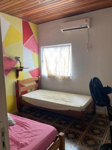 a small room with two beds and a window at Casa de praia no Ariramba, Mosqueiro, Belém/PA. in Belém