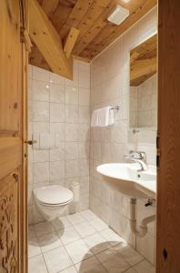 a bathroom with a toilet and a sink at Walliserhof in Täsch