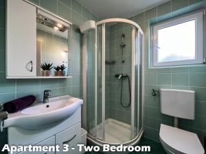 a bathroom with a sink and a shower at Art Apartments Vrsar in Vrsar +65 photos