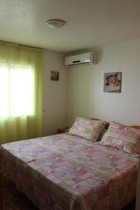 a bedroom with a bed and a window at Los Gases Apartment in Torrevieja
