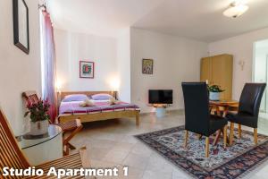 a bedroom with a bed and a table and chairs at Art Apartments Vrsar in Vrsar
