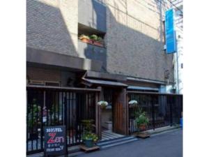 a building with a gate and a sign in front of it at Hostel Zen - Vacation STAY 91859v in Yokohama