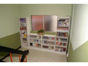 a room with a book shelf filled with dvds at Hostel Zen - Vacation STAY 91867v in Yokohama