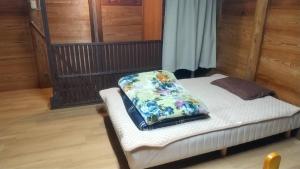 a bed with a pillow on it in a room at Kura "Ika" - Vacation STAY 95263v in Nagahama
