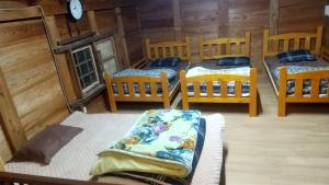 a group of four beds in a room at Kura "Ika" - Vacation STAY 95263v in Nagahama