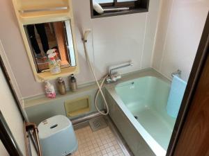 a small bathroom with a tub and a toilet at Kura "Ika" - Vacation STAY 95263v in Nagahama