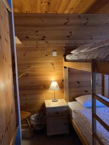 a bedroom with two bunk beds in a log cabin at B&B Chalet Rey-Bellet in Les Crosets