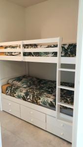 a white bunk bed in a room at Garden and beach sea view apartment Cannes in Cannes