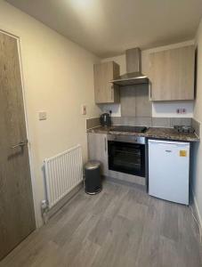 a kitchen with a refrigerator and a counter top at 5. Homely Cecil Apartments in Birmingham