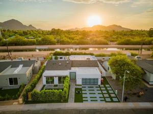 an aerial view of a house with the sunset in the background at Luxury Villa 5mins to Old Town w Pool Fire pit and BBQ in Scottsdale