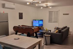 a living room with a piano and a couch at Maison " Pac-Man" entre collègues, amis, famille - barbecue - Netflix - Prime - Baby foot 50cts - jusqu'à 9 personnes - in Saint-Seurin-sur-lʼIsle
