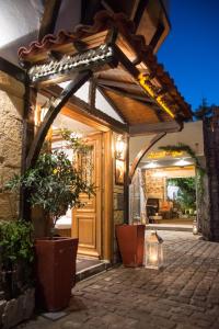 an entrance to a house with a wooden door at Arxontiko Hotel in Myrina