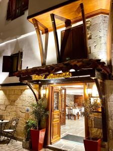 an entrance to a building with a wooden door at Arxontiko Hotel in Mirina