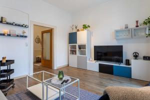 a living room with a table and a tv at Apartment 54 - Ferienwohnung Bad Arolsen in Bad Arolsen