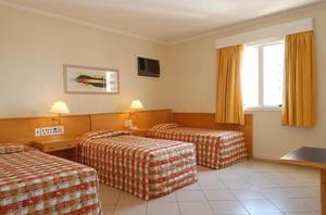 Postel nebo postele na pokoji v ubytování Jaguary Hotel Sumaré