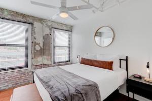 Un dormitorio con una cama blanca y un espejo. en Historic South Main Gem with Modern updates, en Memphis