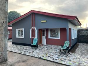 a small house with two chairs in front of it at Nabixx Residence in Brufut