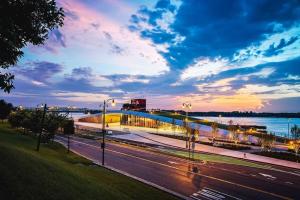 a bridge over a road with a river and a sunset at Historic Revival Downtown in Memphis