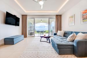 a living room with a couch and a tv at La Vista 2 - Diriá Tamarindo in Tamarindo