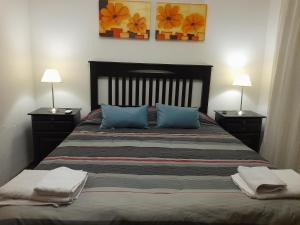 En eller flere senge i et værelse på Amplio y Centrico