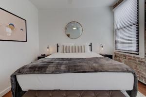 a bedroom with a large bed and a brick wall at Handsomely Historic Place in Memphis