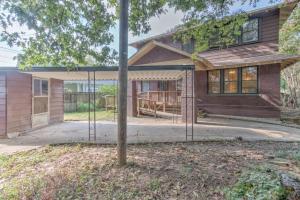 a home with a porch and a house at Beautiful Bungalow Stones throw from Cooper Young in Memphis