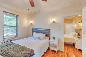 a bedroom with two beds and a mirror at Beautiful Bungalow Stones throw from Cooper Young in Memphis