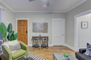 een woonkamer met een groene stoel en een tafel bij Twin Bungalows Near Cooper Young in Memphis
