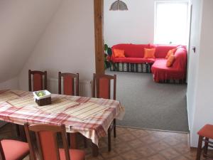 a living room with a table and a couch at Prázdninový dům Josefův Důl in Josefŭv Dŭl