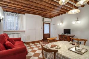 a living room with a red couch and a table at Nice Venice Apartments in San Marco in Venice