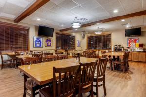 a dining room with wooden tables and chairs at Best Western Plus Dubuque Hotel and Conference Center in Dubuque