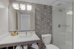 a bathroom with a sink and a toilet and a shower at Best Western Plus Brooklyn Bay Hotel in Brooklyn +36 photos