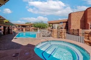 a swimming pool in a yard with a building at Best Western Red Hills in Kanab